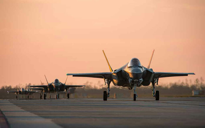 2465804971 Jets on runway at sunset.