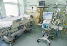 Hospital bed with medical equipment and monitors.