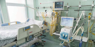 Hospital bed with medical equipment and monitors.