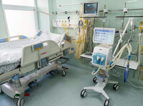 Hospital bed with medical equipment and monitors.